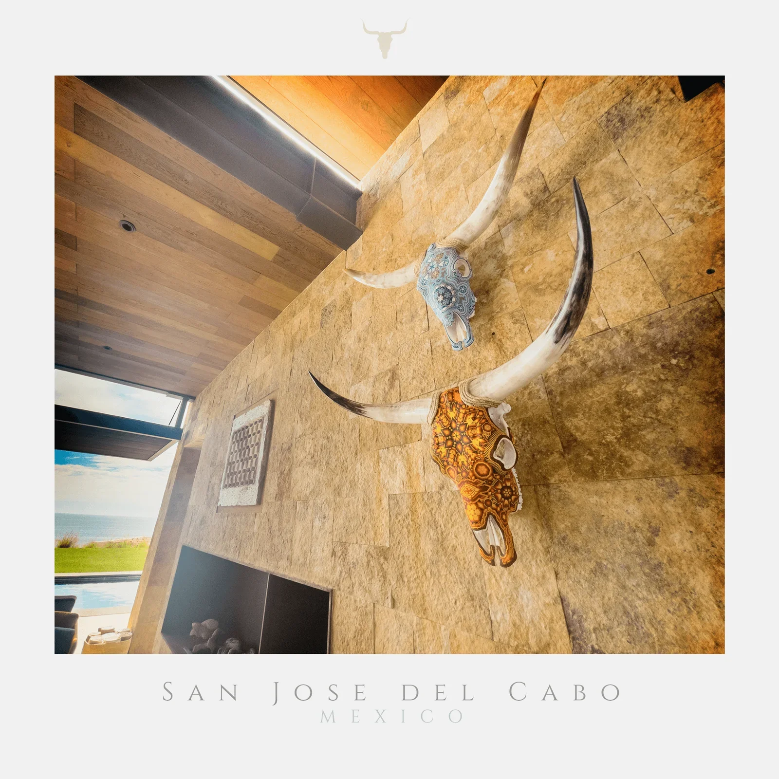 Two Cabokero artworks on a warm stone wall in a client's San José del Cabo home
