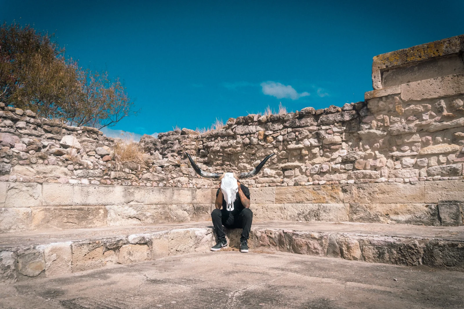 Ricardo Quero with an artwork among the stone architecture of Mitla