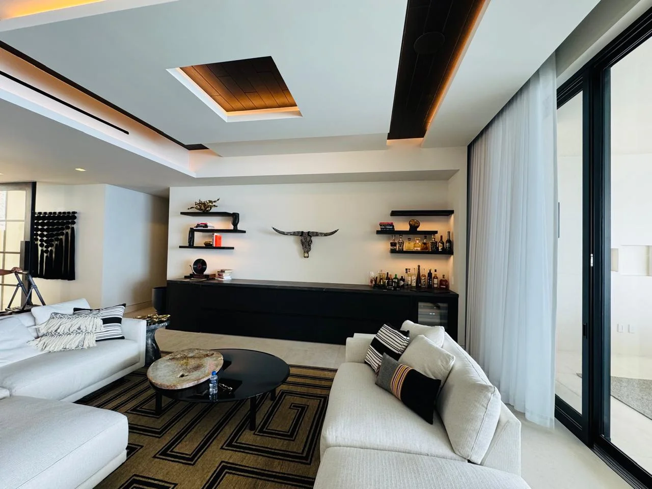 Cabokero artwork above a home bar in a contemporary living room
