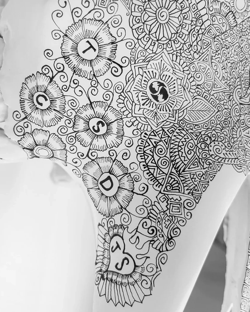 Family initials drawn among black geometric patterns on a white commissioned artwork
