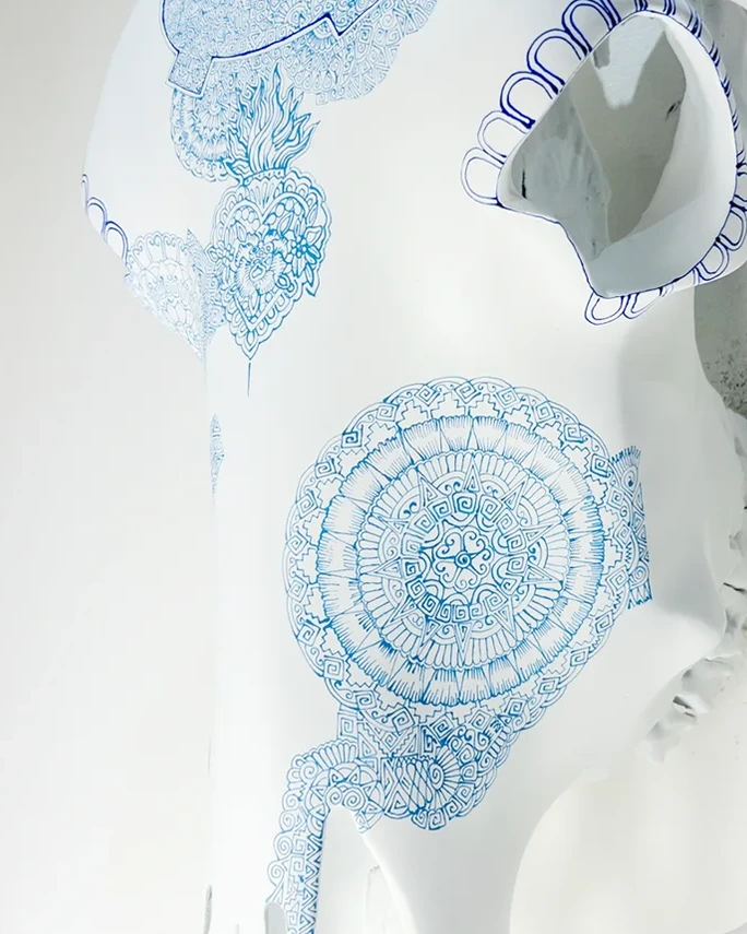 Pale blue circular symbols on a white Cabokero piece