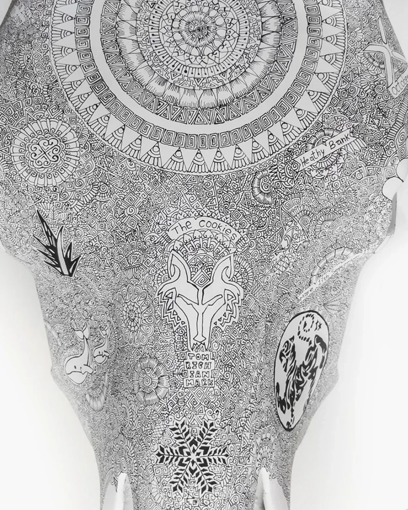 Black fine linework and personal motifs covering a white commissioned piece
