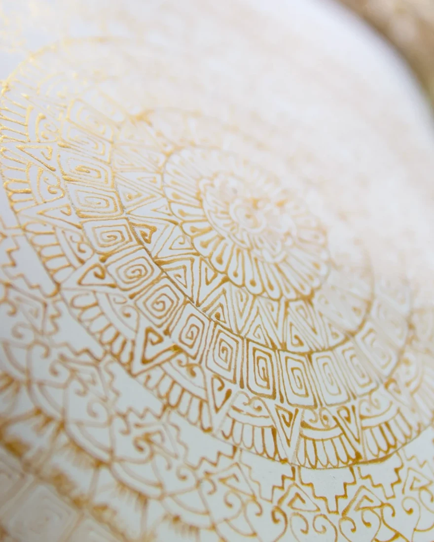Golden circular patterns on a white Cabokero commission